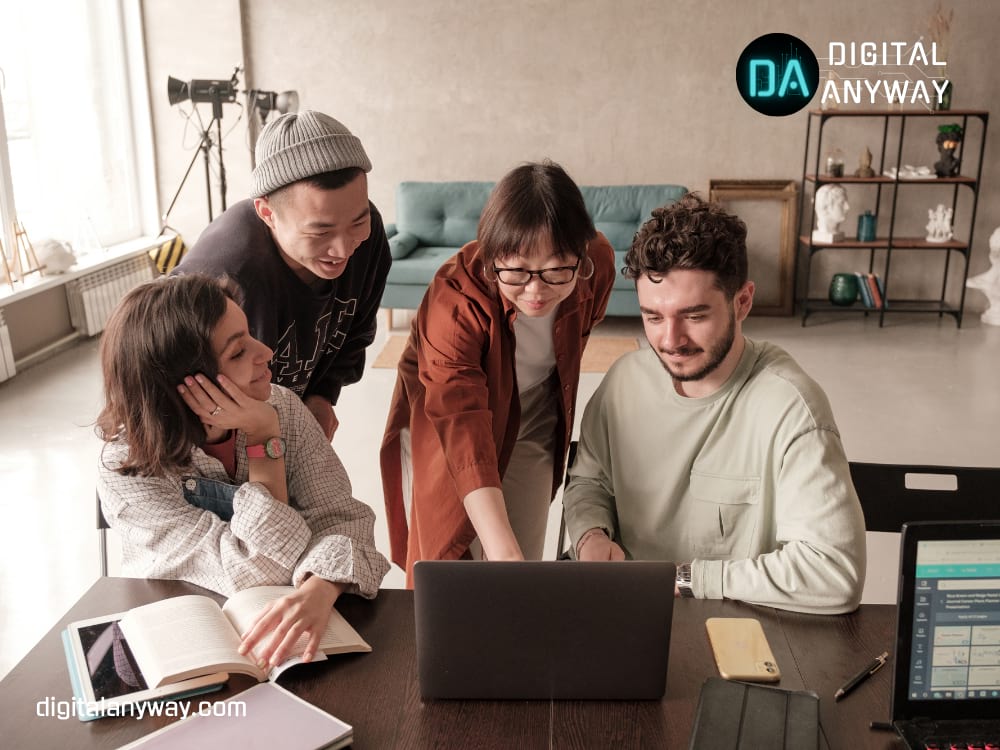 Four people looking at the laptop